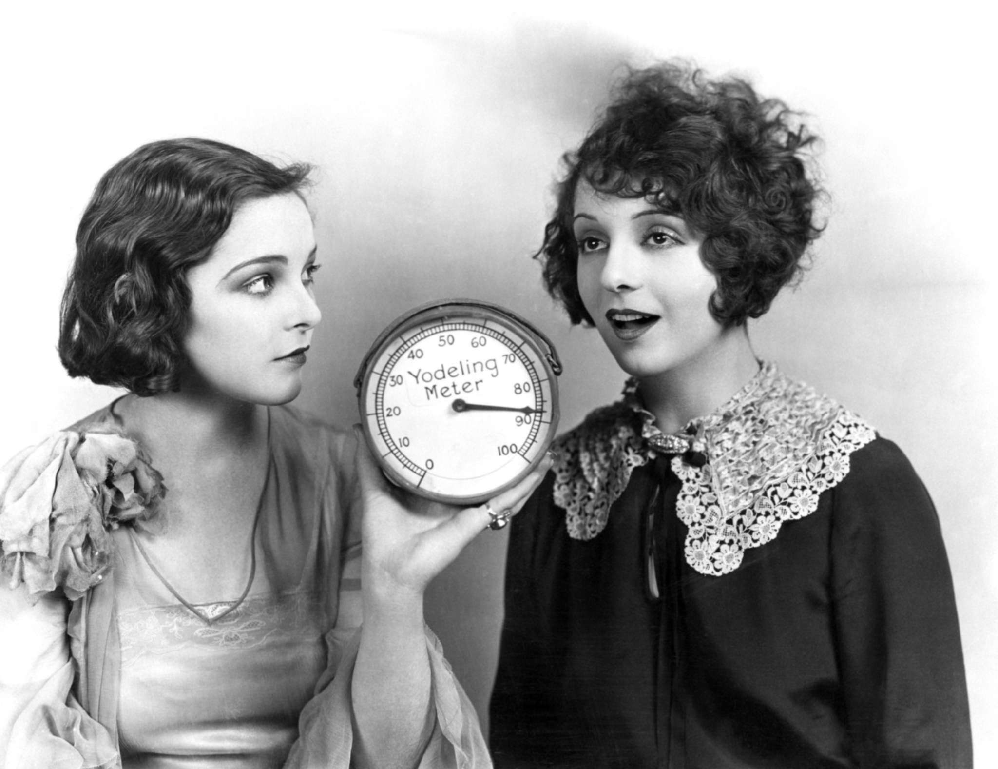 Vintage photograph of two women measuring their yodelling level with a meter